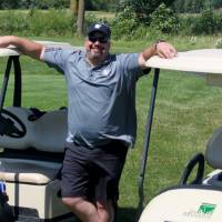 man with hands on golf carts